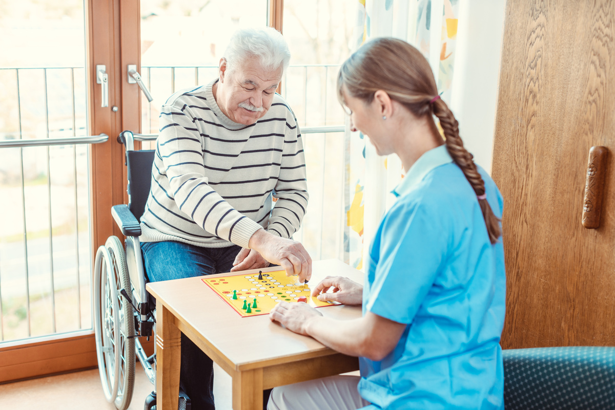 Nurse and Elderly Man Playing a Board Game  