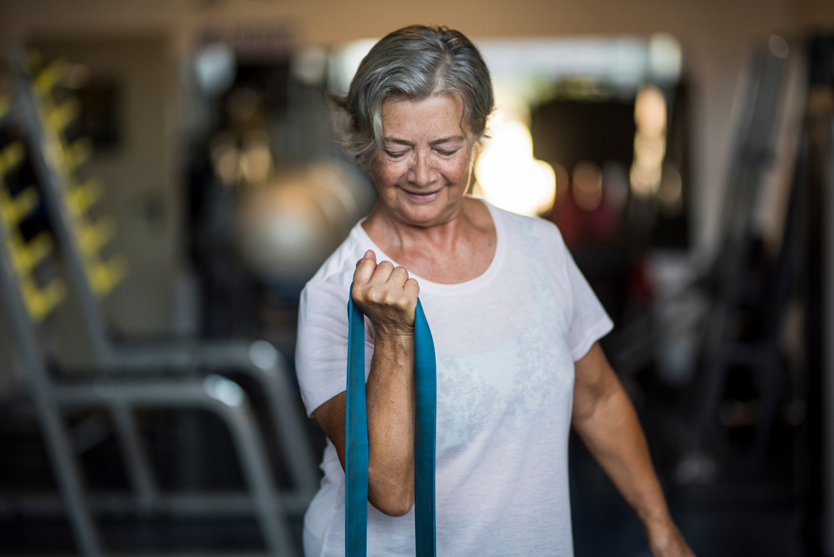 Elderly Woman Exercising in the Gym